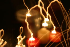 Image of candles with light trails in an arc.